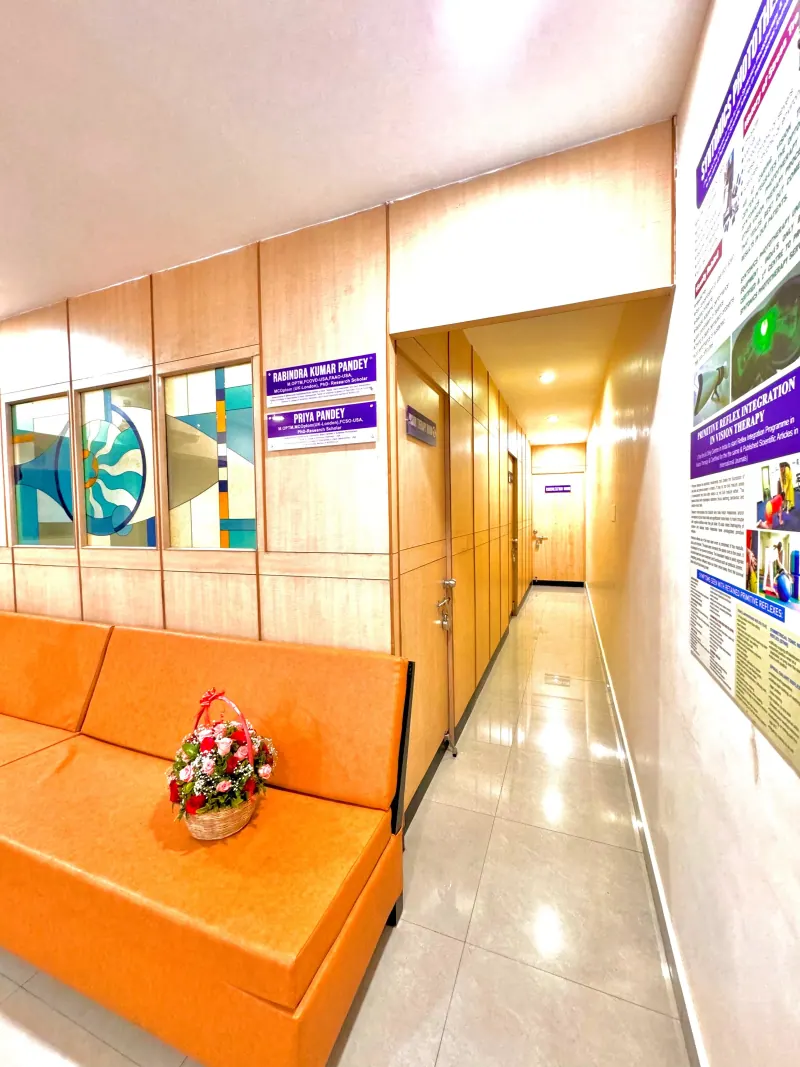Caring Vision Therapy Anna Nagar Chennai - Clinic corridor with waiting sofa leading to therapy and consultation rooms
