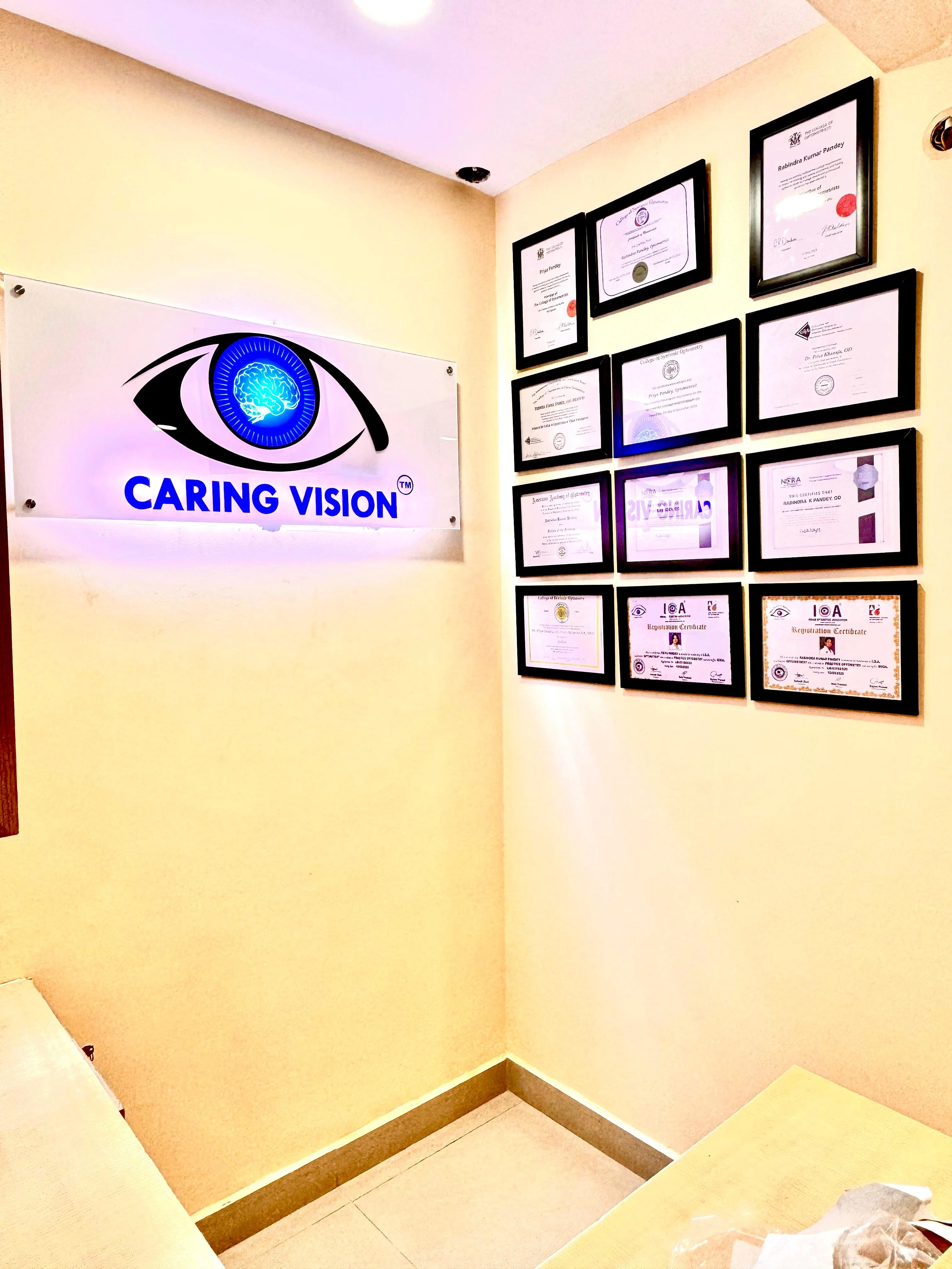 Caring Vision Therapy Anna Nagar Chennai – Reception area with illuminated clinic logo and professional credentials wall