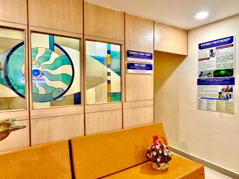 Caring Vision Therapy Anna Nagar Chennai - Patient waiting area with Syntonics phototherapy poster and doctor name boards