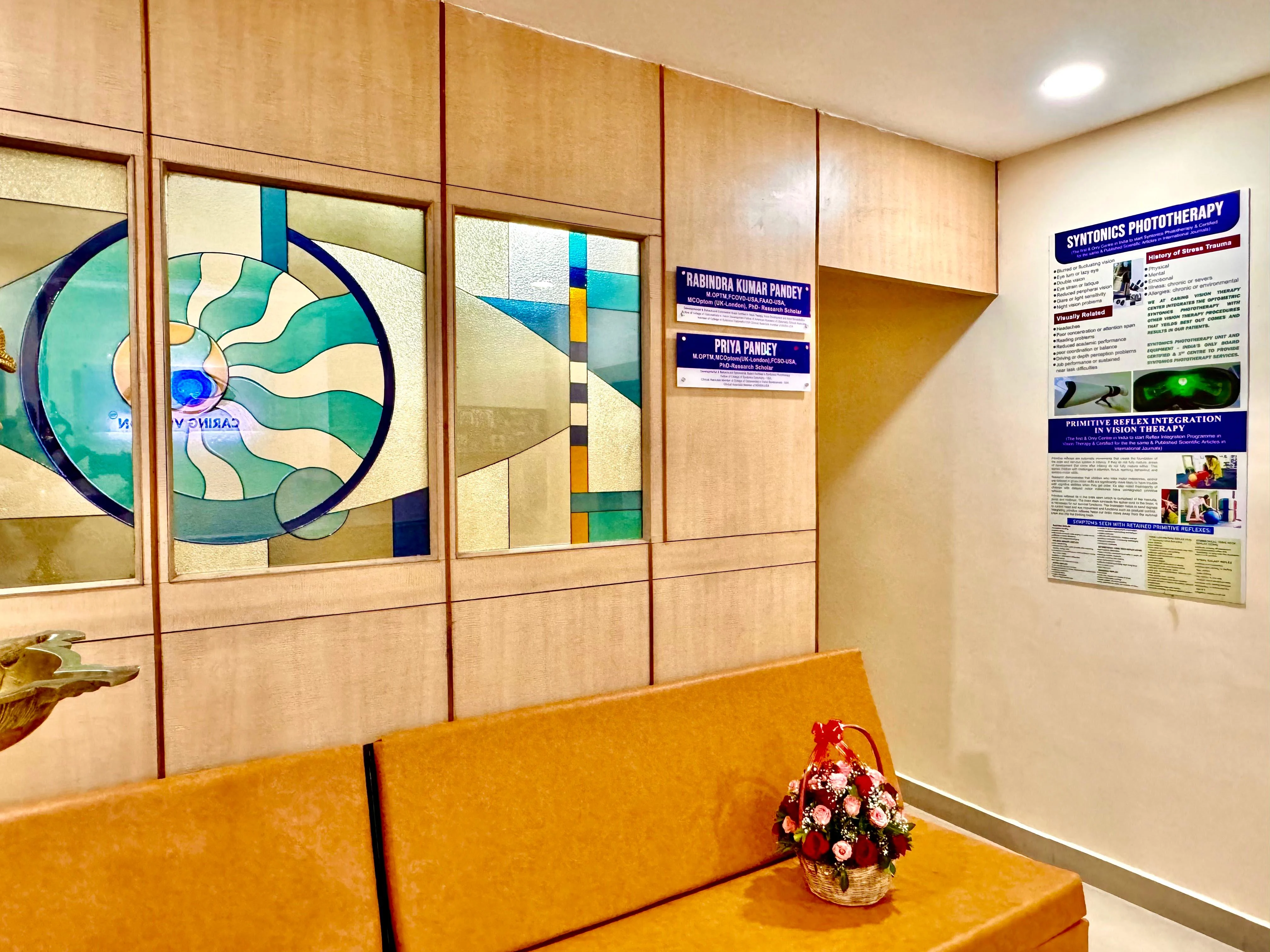 Caring Vision Therapy Anna Nagar Chennai – Patient waiting area with Syntonics phototherapy poster and doctor name boards