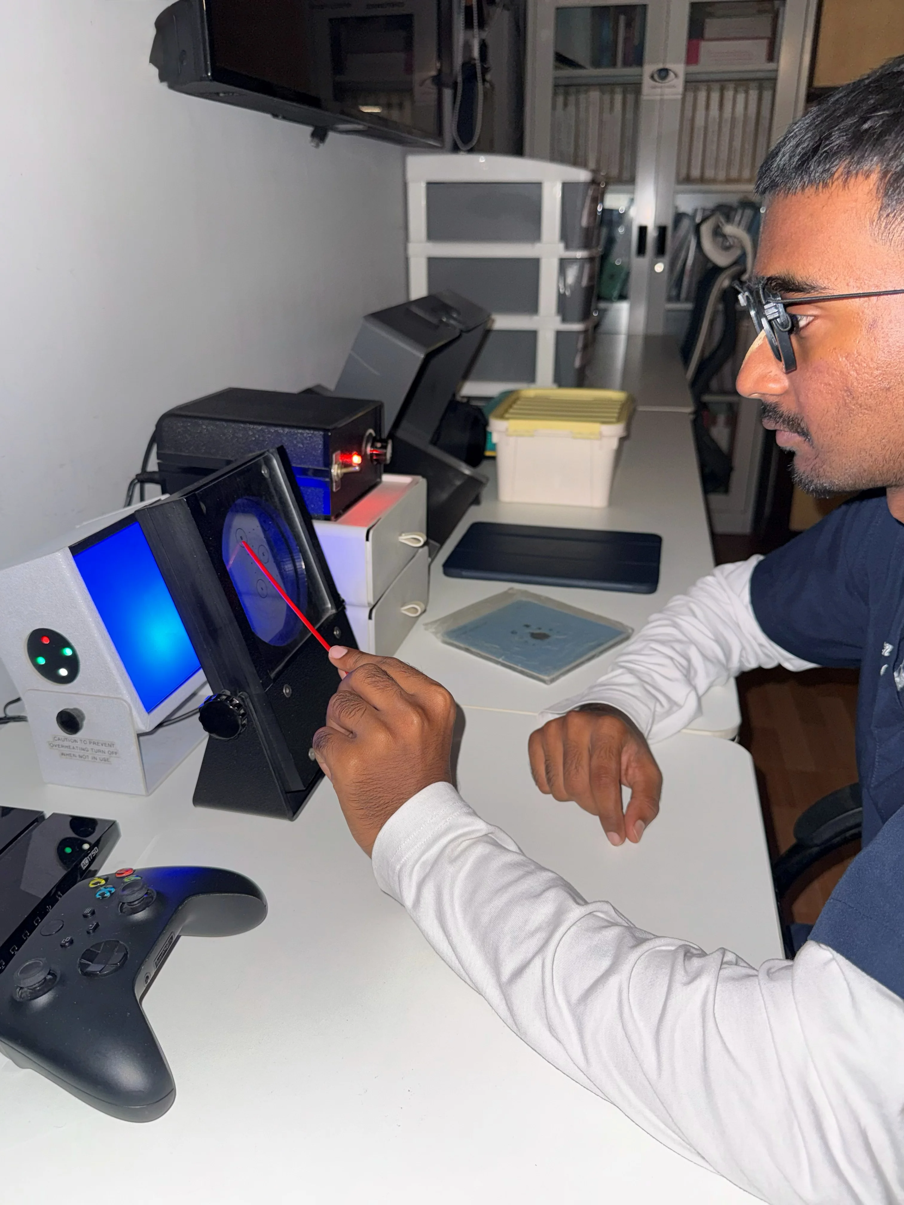 Caring Vision Therapy Ashok Nagar Chennai - Patient wearing red-blue anaglyph glasses during tablet-based stereopsis exercise