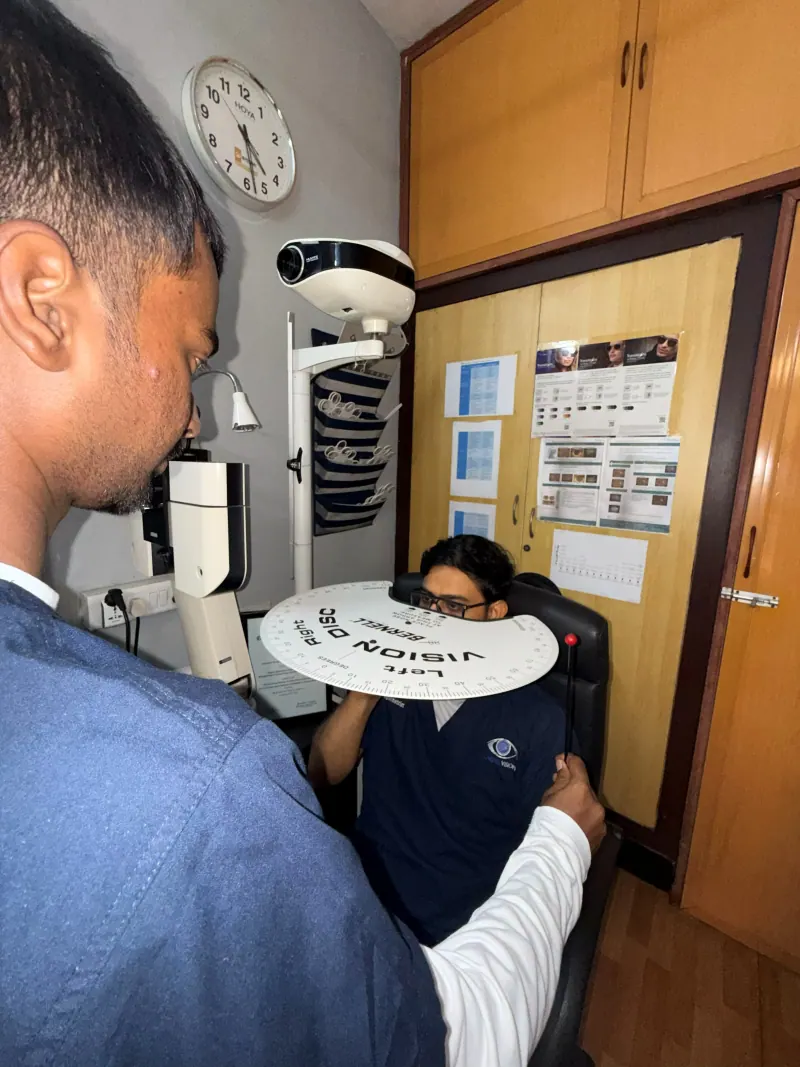 Caring Vision Therapy Ashok Nagar Chennai - Patient holding Caring Vision branded disc during clinic visit