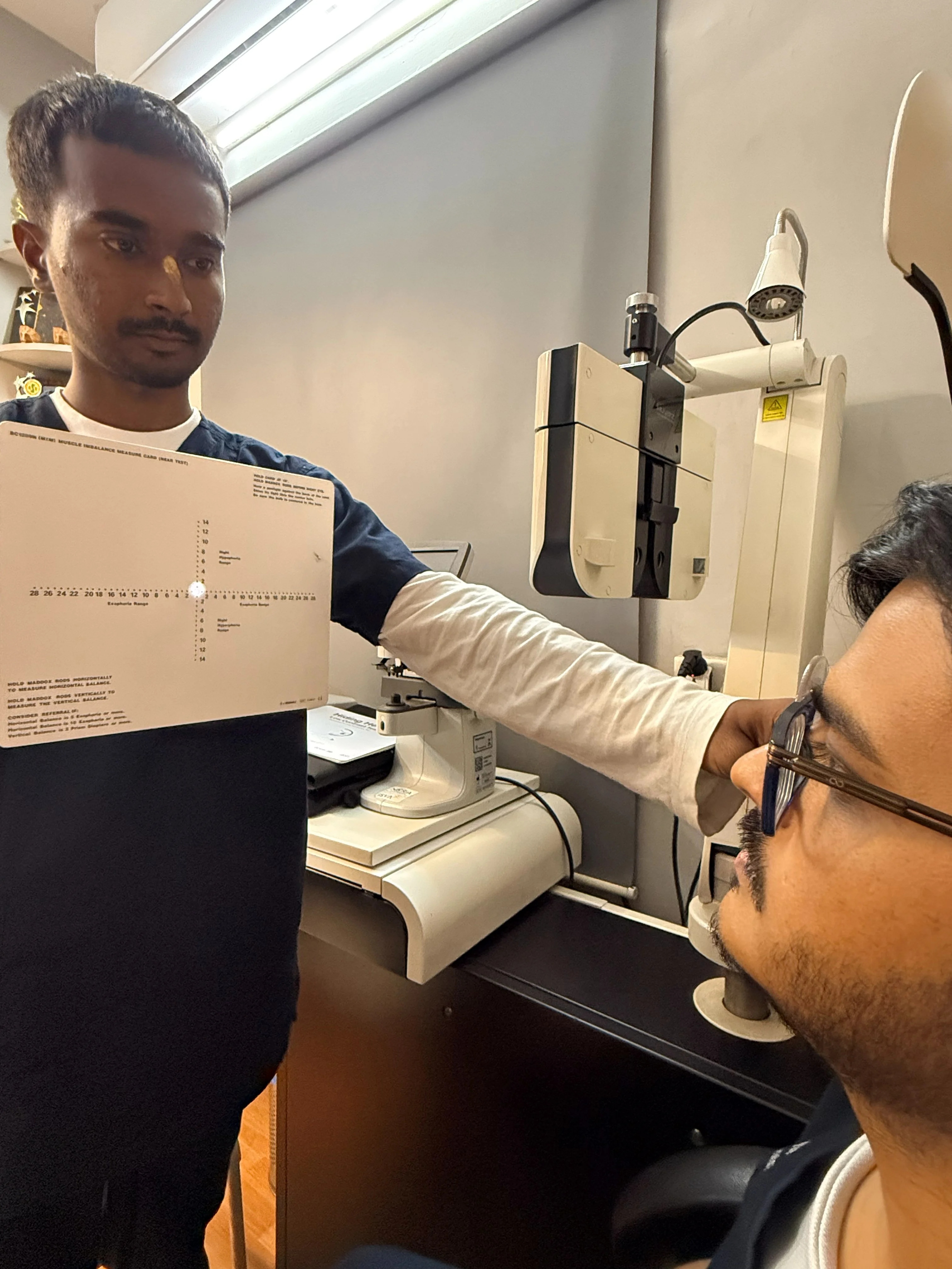 Caring Vision Therapy Ashok Nagar Chennai - Close-up of doctor adjusting diagnostic instrument during clinical assessment