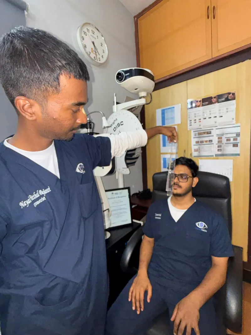 Doctor carrying out a clinical vision assessment at a diagnostic instrument