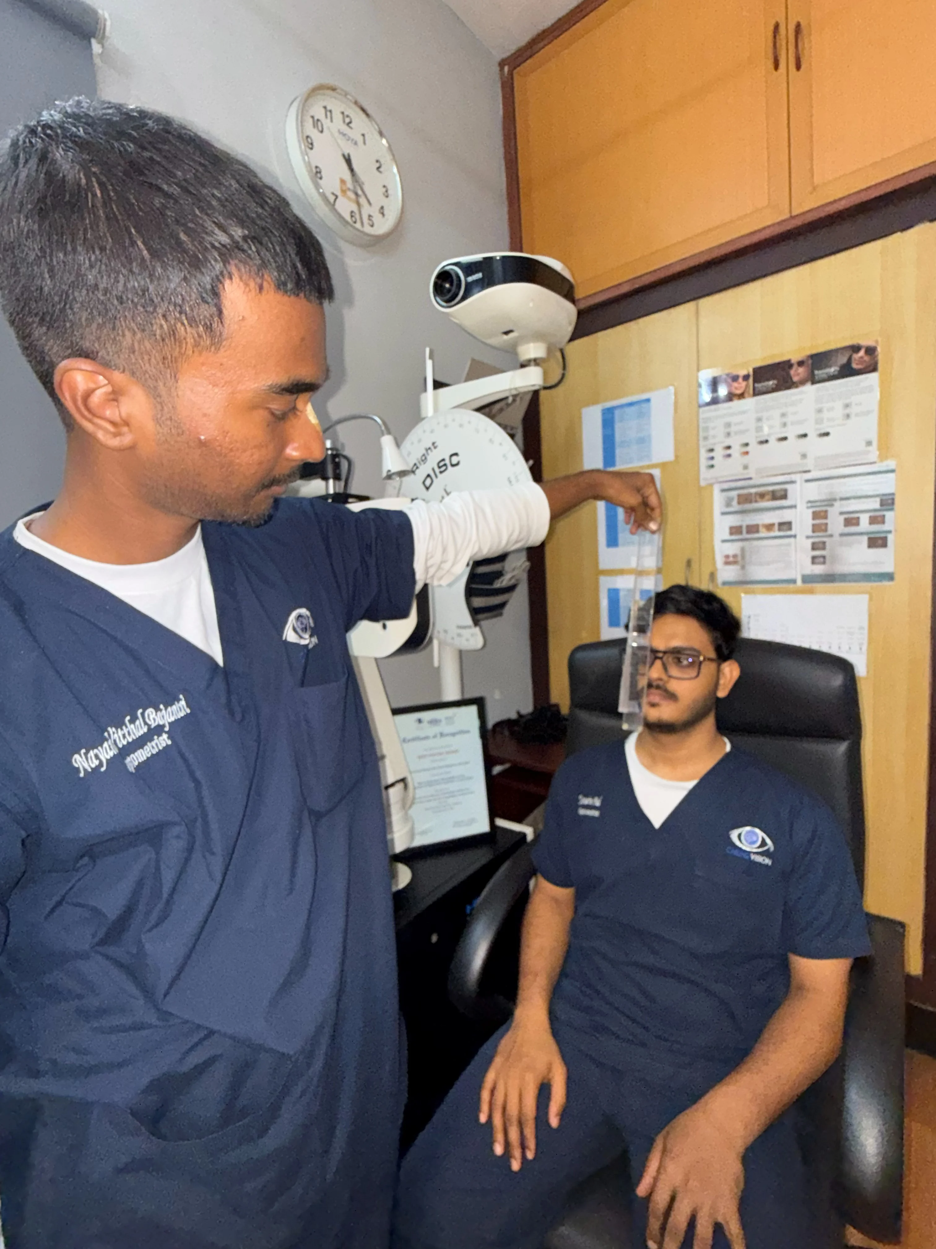 Caring Vision Therapy Ashok Nagar Chennai - Doctor conducting clinical vision assessment with patient at diagnostic instrument