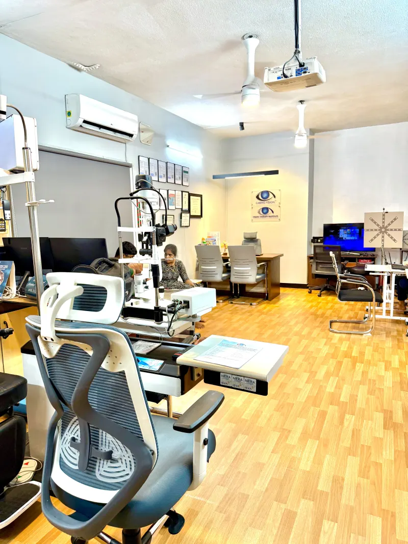 Caring Vision Therapy Ashok Nagar Chennai - Diagnostic and therapy floor with slit lamp, examination chairs and active therapy stations