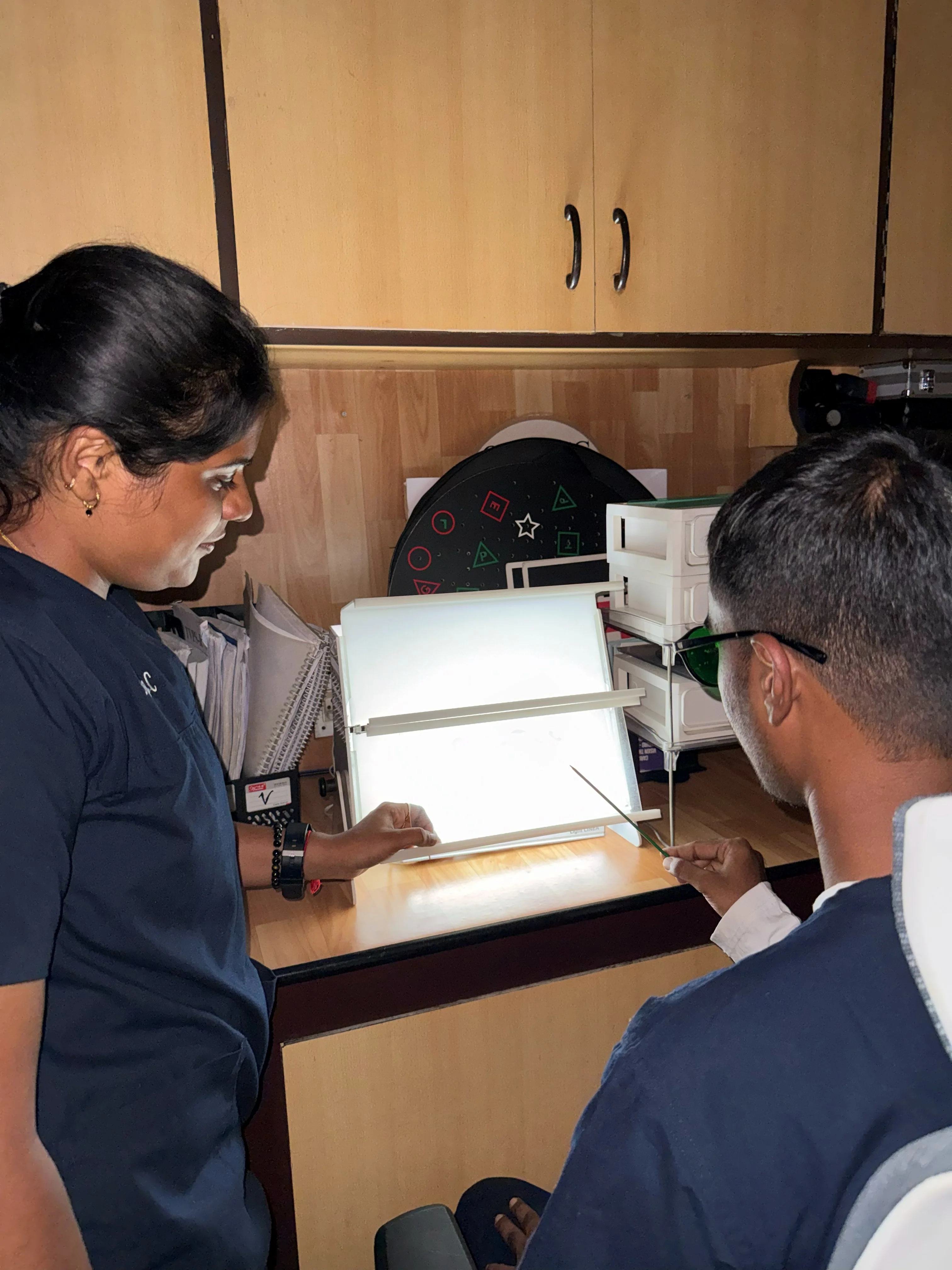 Caring Vision Therapy Ashok Nagar Chennai - Therapist conducting eye movement assessment session with patient