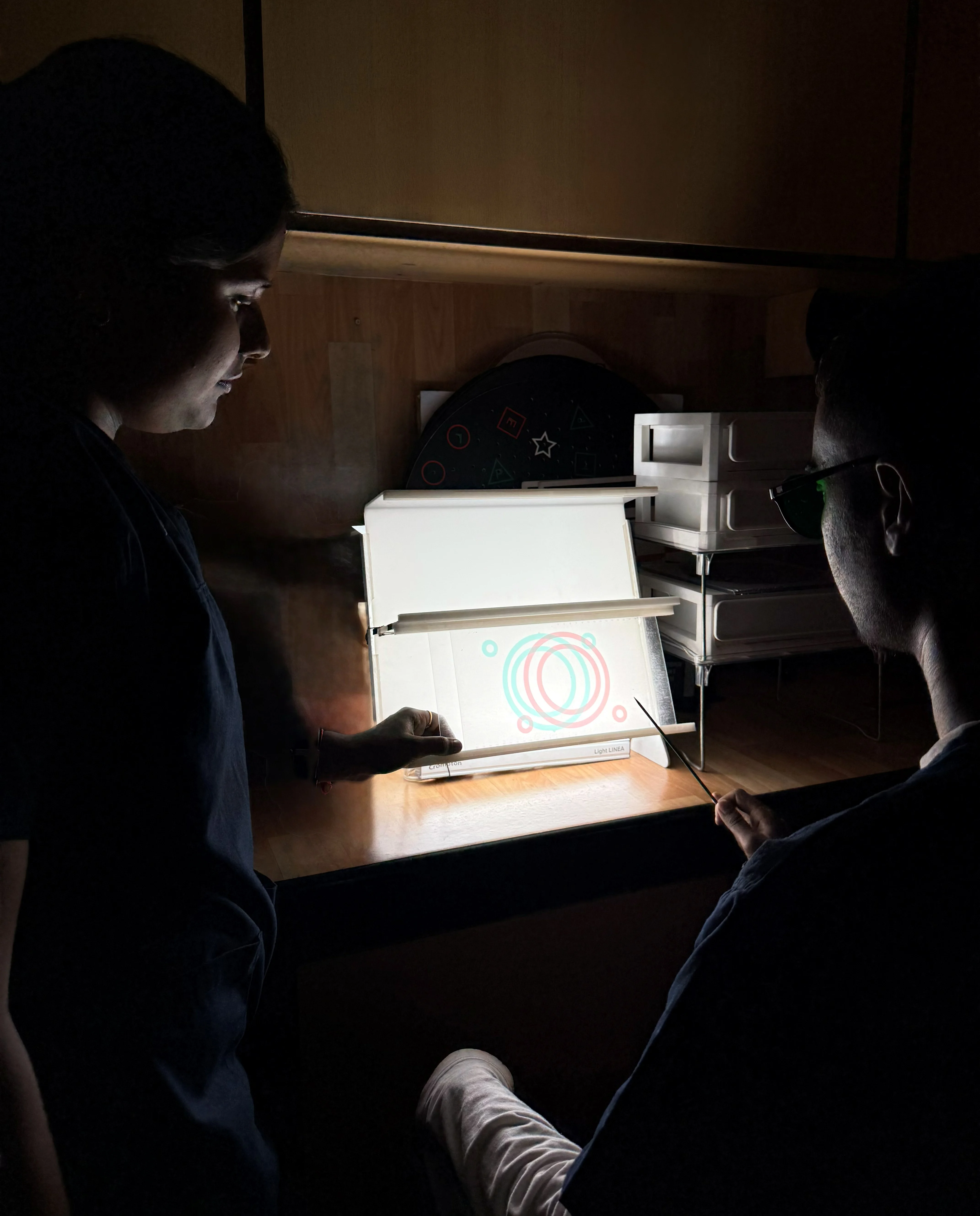 Caring Vision Therapy Ashok Nagar Chennai - Patient performing illuminated fusion target exercise on light box