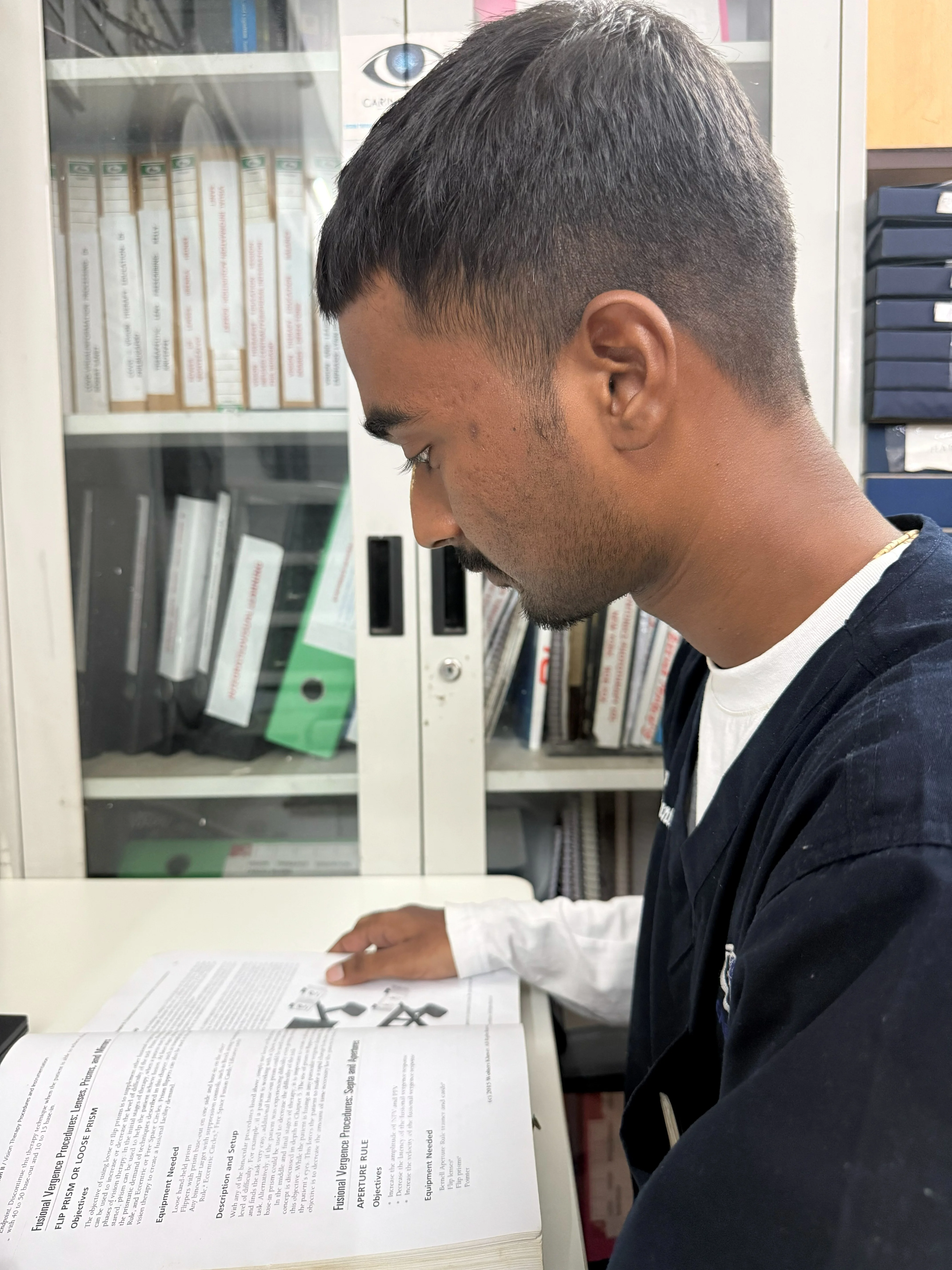 Caring Vision Therapy Ashok Nagar Chennai - Therapist reviewing patient vision therapy reports at desk