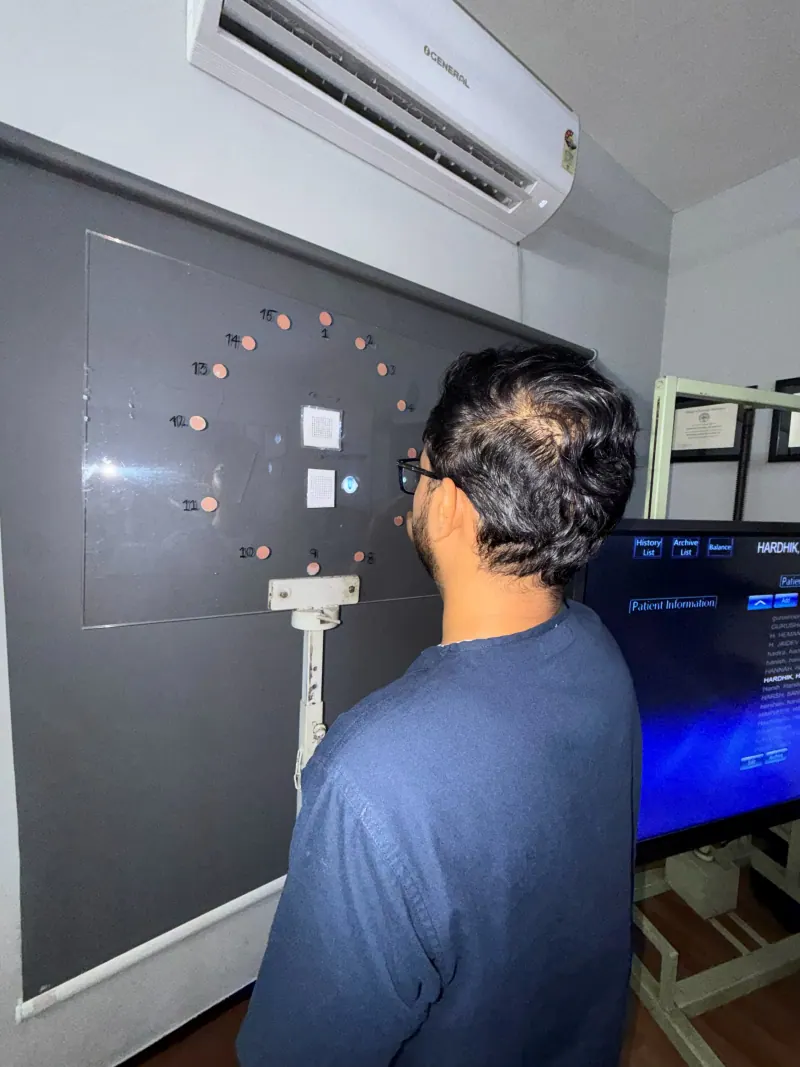 Caring Vision Therapy Ashok Nagar Chennai - Patient undergoing peripheral vision reaction training on wall panel