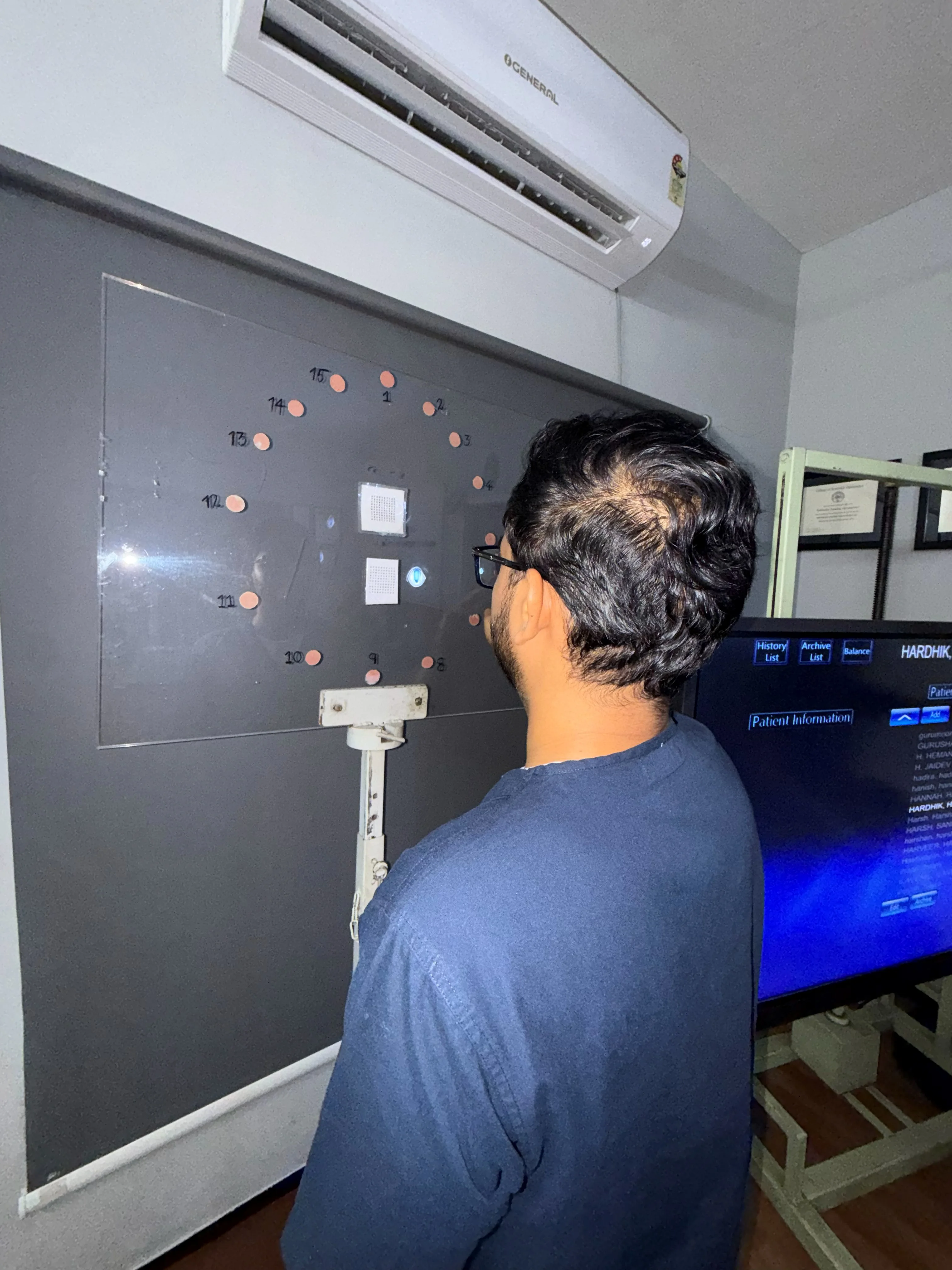 Caring Vision Therapy Ashok Nagar Chennai - Patient undergoing peripheral vision reaction training on wall panel