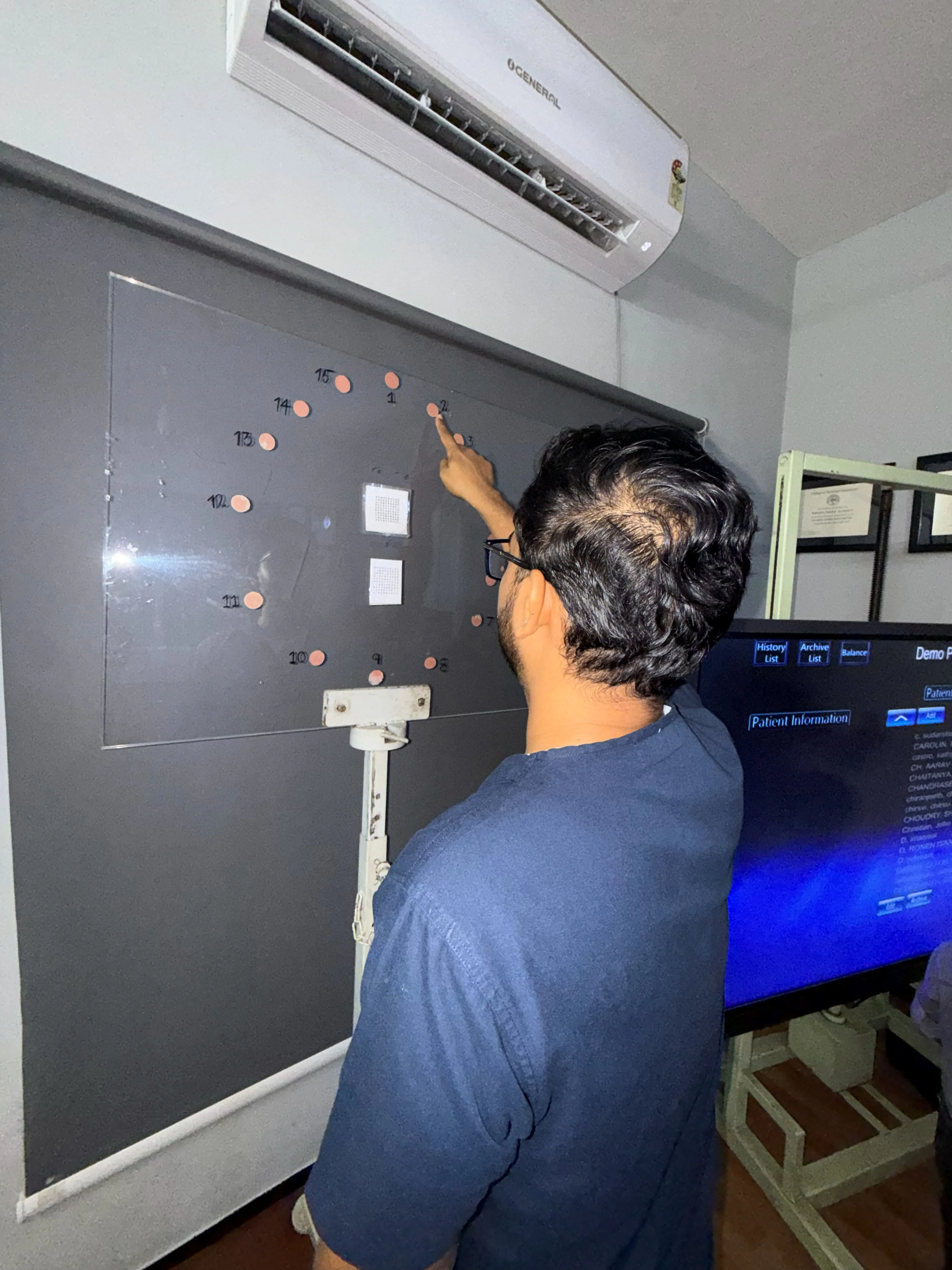 Caring Vision Therapy Ashok Nagar Chennai - Patient performing peripheral vision exercise on illuminated wall panel
