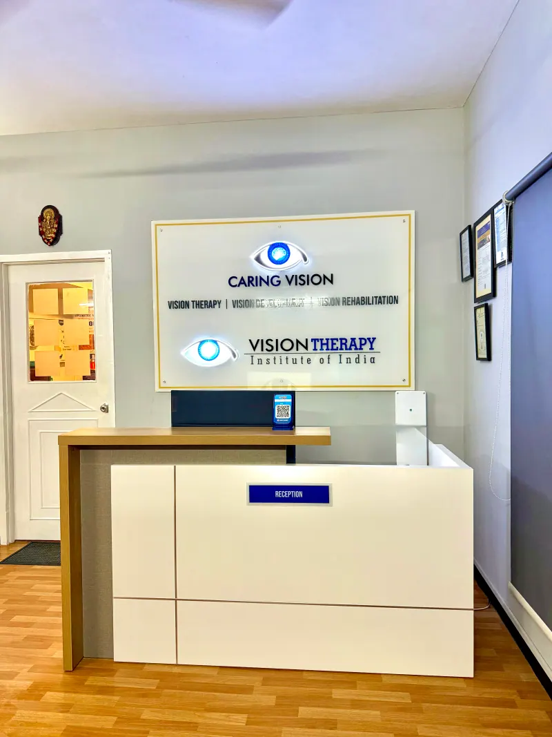 Caring Vision Therapy Ashok Nagar Chennai - Reception desk with Caring Vision and Vision Therapy Institute of India branding