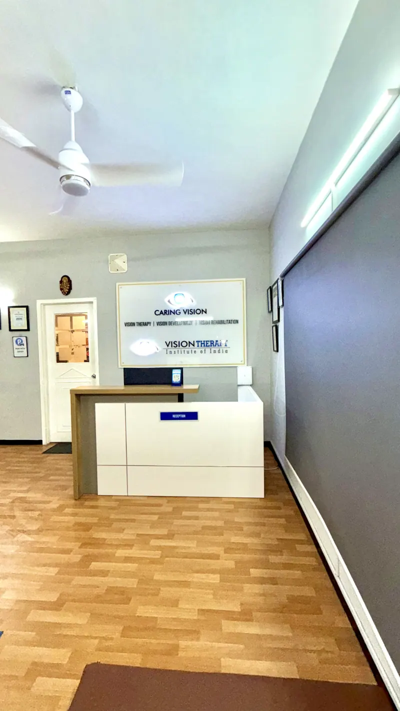 Caring Vision Therapy Ashok Nagar Chennai - Wide-angle view of reception entrance with Caring Vision and Vision Therapy Institute of India branding