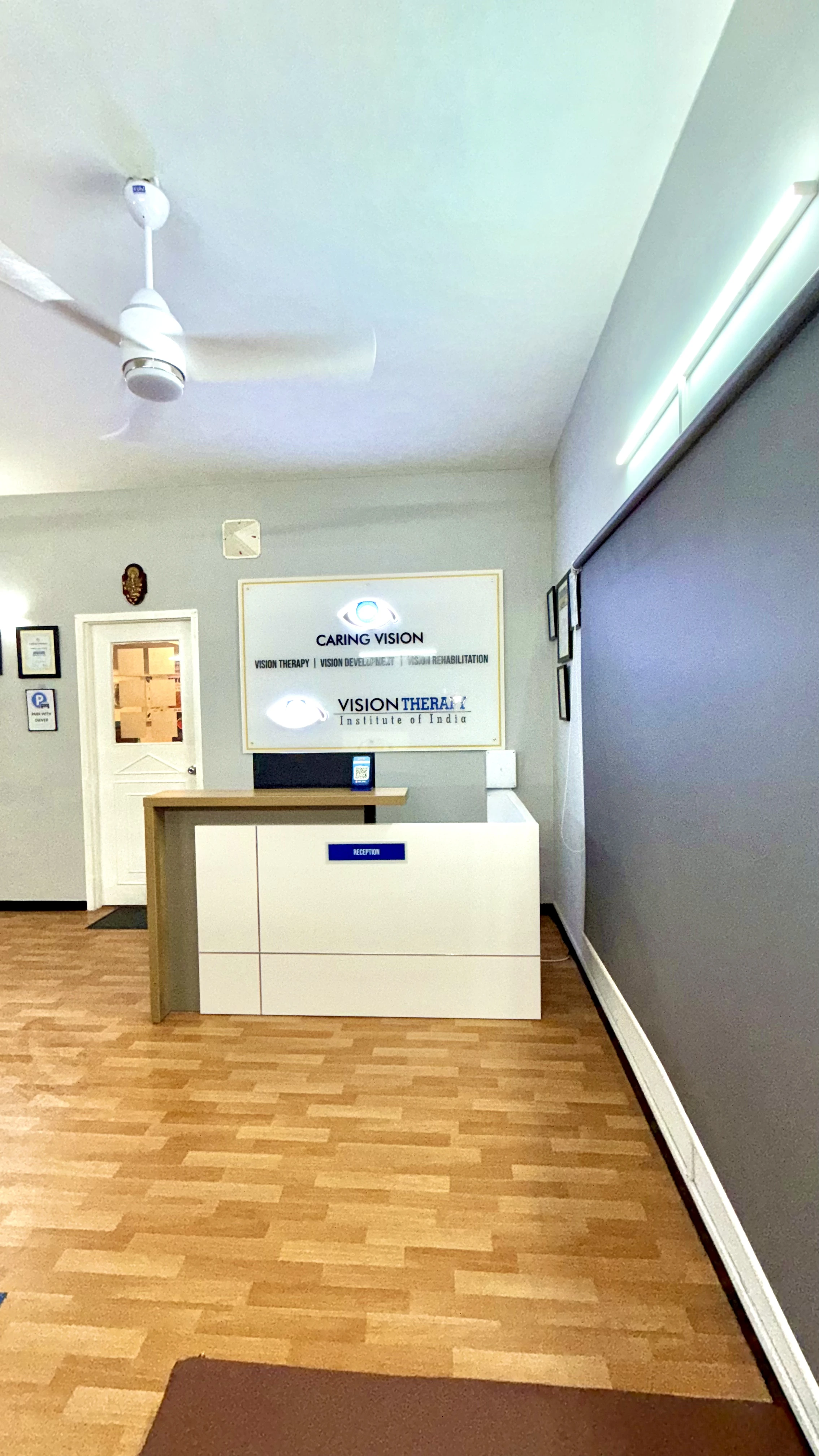 Caring Vision Therapy Ashok Nagar Chennai – Wide-angle view of reception entrance with Caring Vision and Vision Therapy Institute of India branding