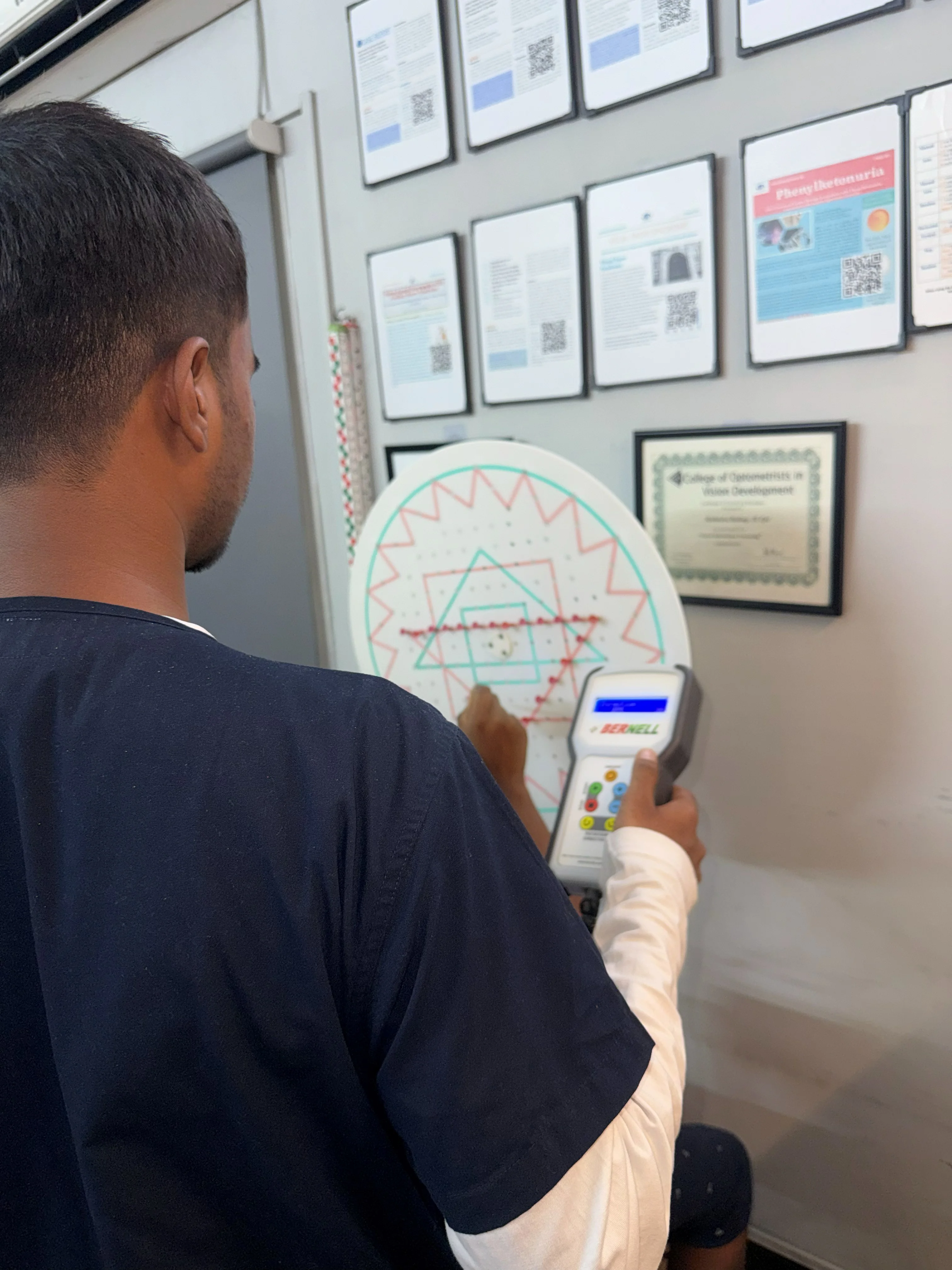 Caring Vision Therapy Ashok Nagar Chennai - Patient during saccadic training session using wall-mounted circular chart