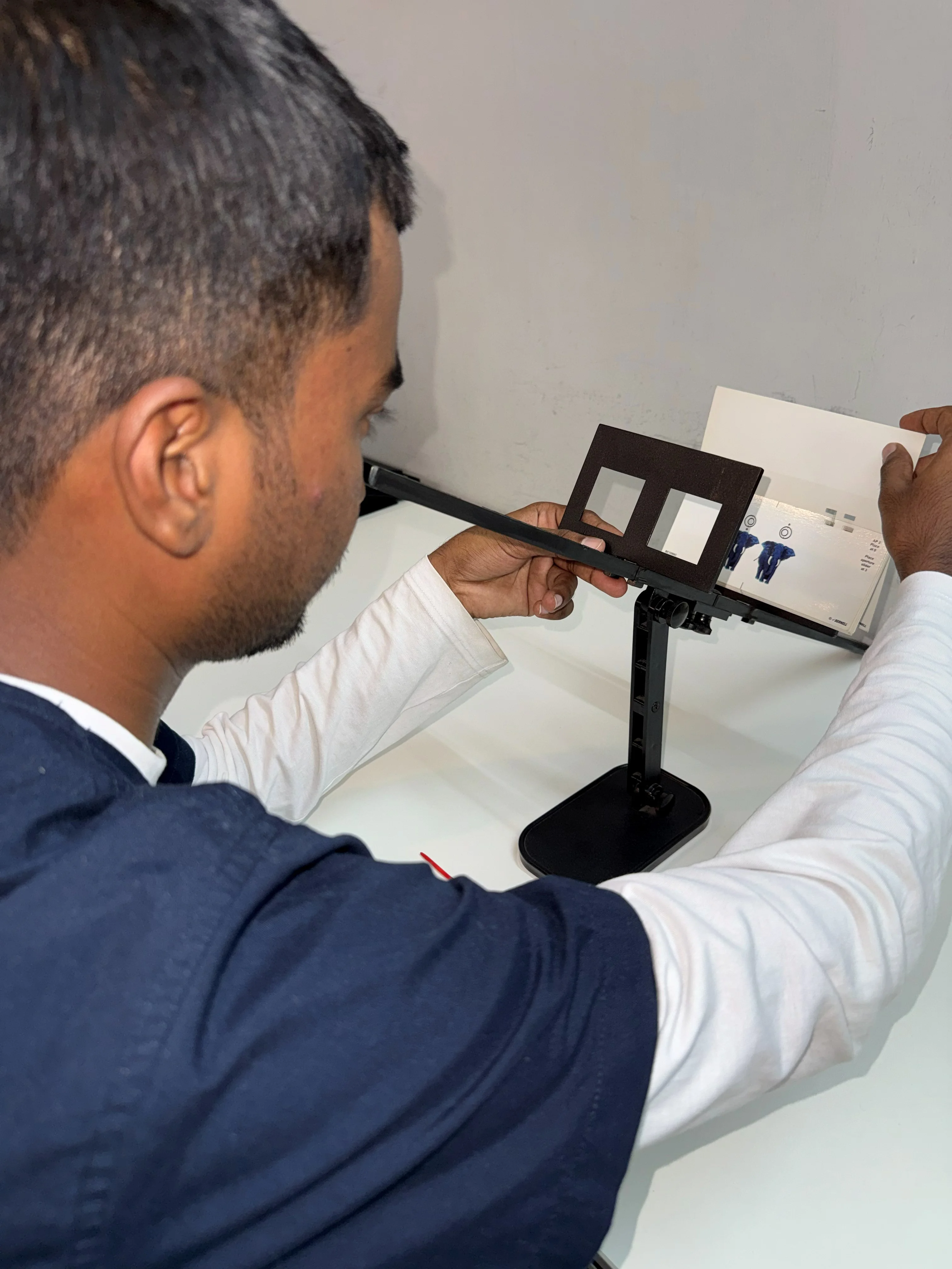 Caring Vision Therapy Ashok Nagar Chennai - Patient performing fusion card exercise on stand-mounted stereoscope
