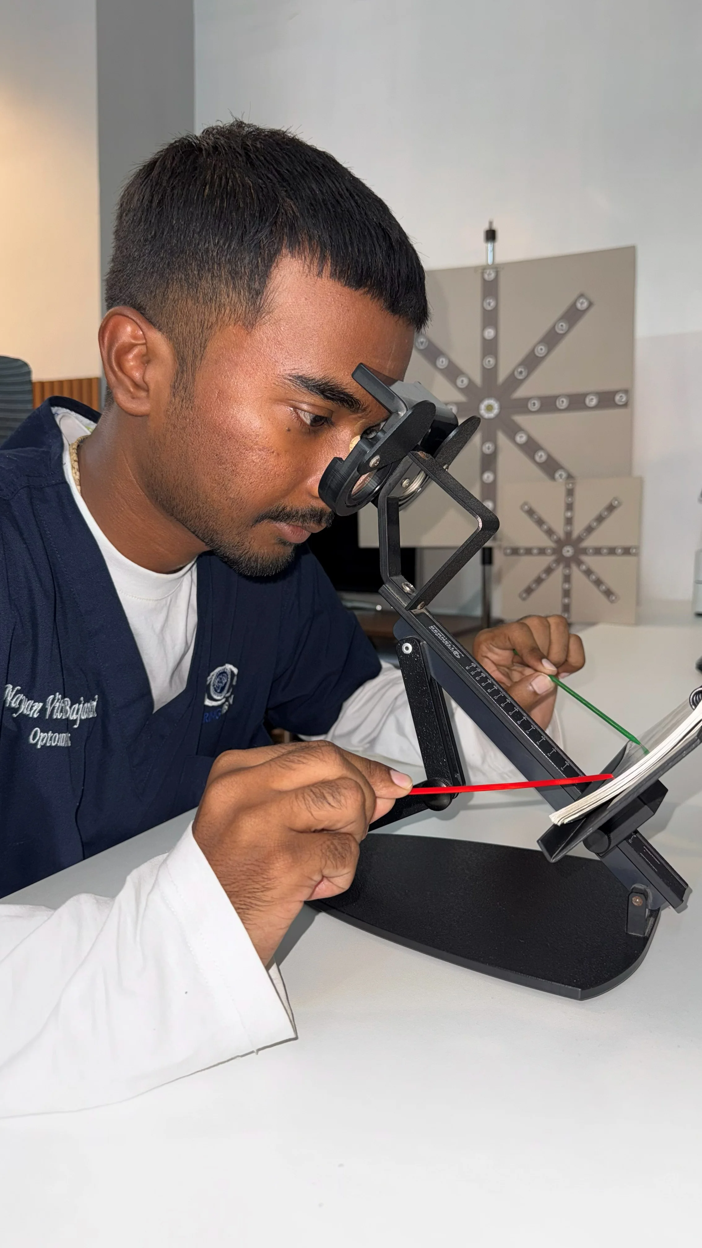 Caring Vision Therapy Ashok Nagar Chennai - Therapist conducting synoptophore binocular vision assessment while marking fusion worksheet