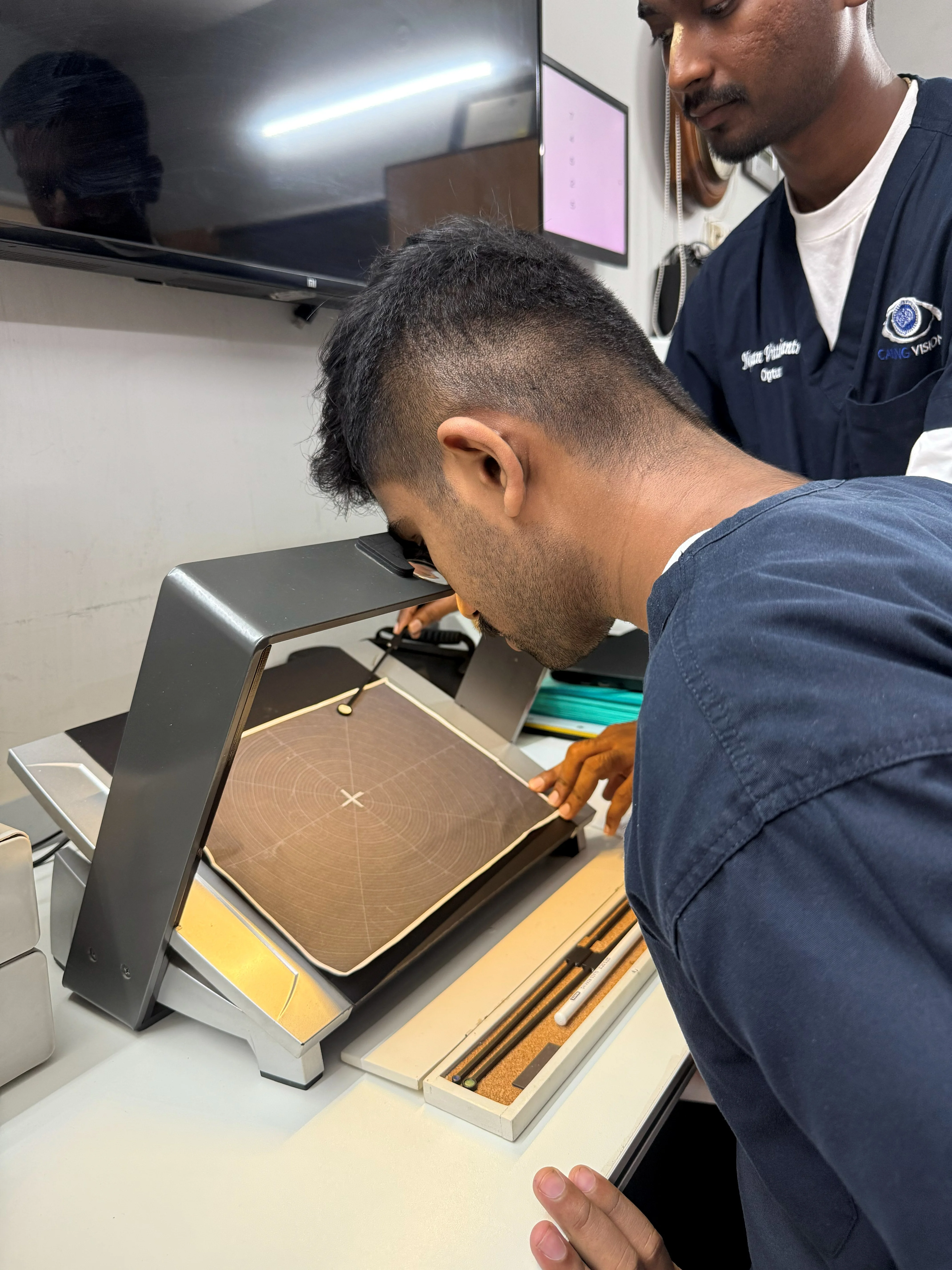 Caring Vision Therapy Ashok Nagar Chennai - Patient using tabletop hood viewer for binocular vision exercise