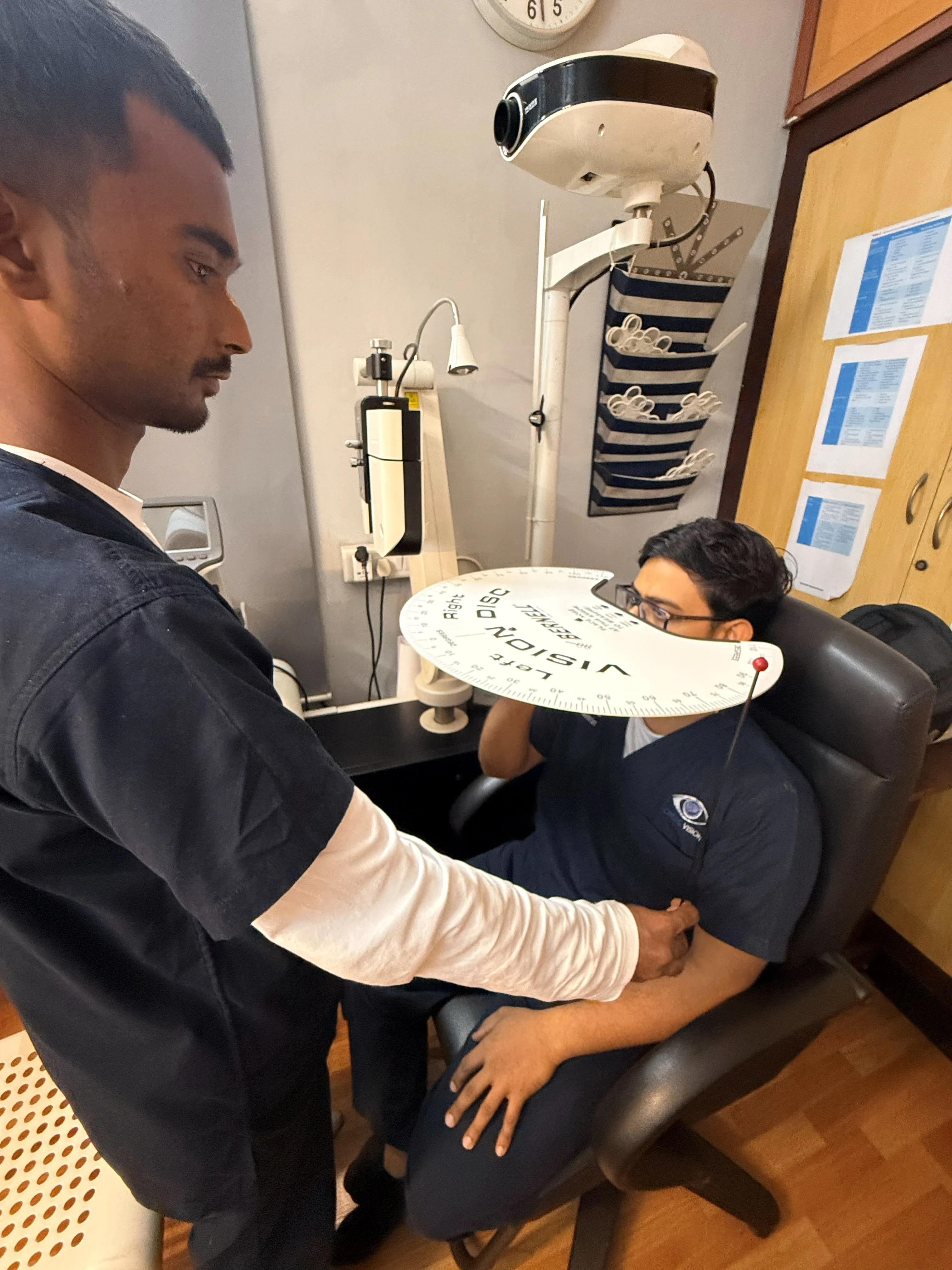 Caring Vision Therapy Ashok Nagar Chennai - Patient undergoing visual field assessment session with doctor