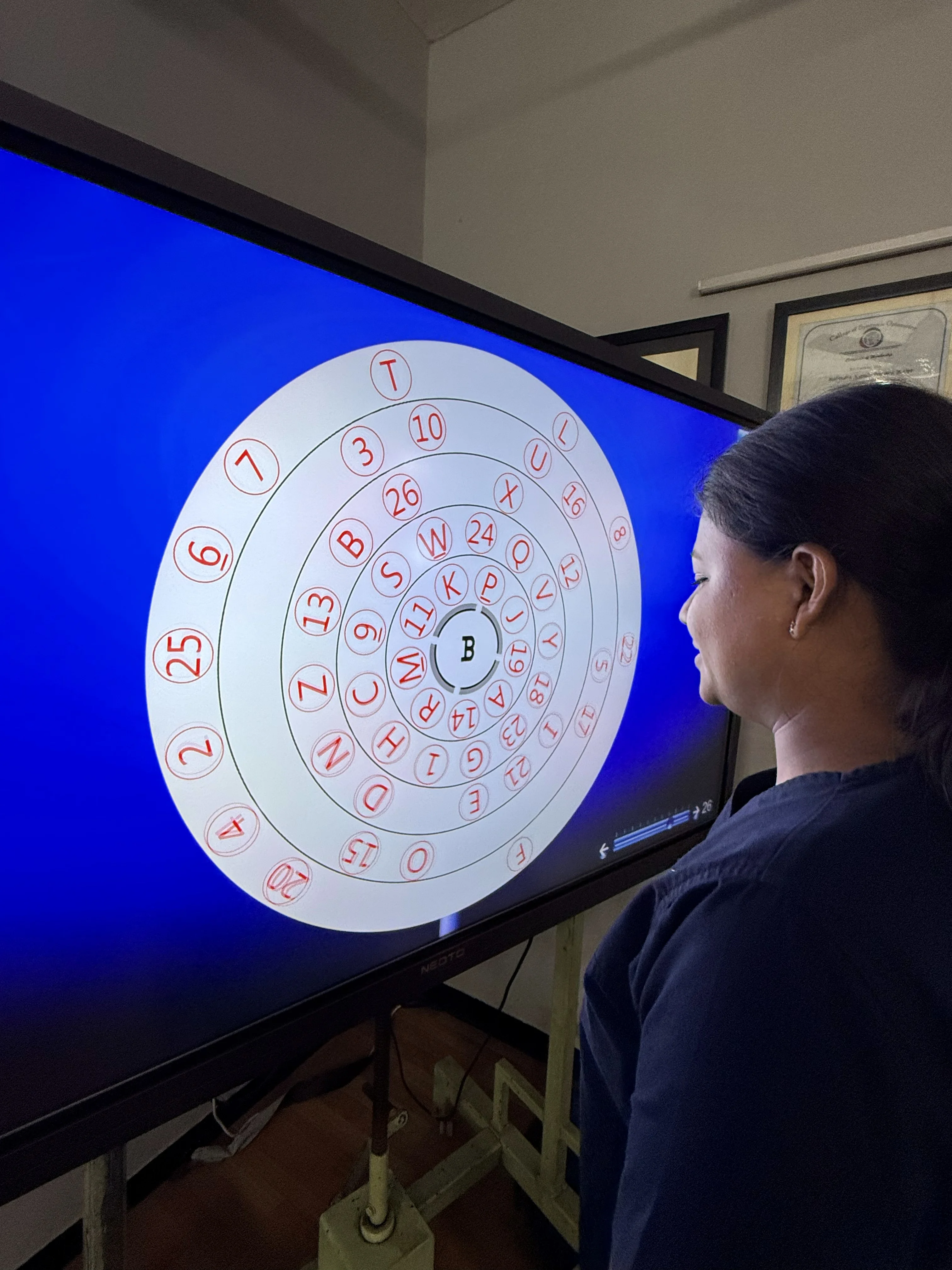 Caring Vision Therapy Ashok Nagar Chennai - Therapist guiding patient through visual tracking exercise on large display screen