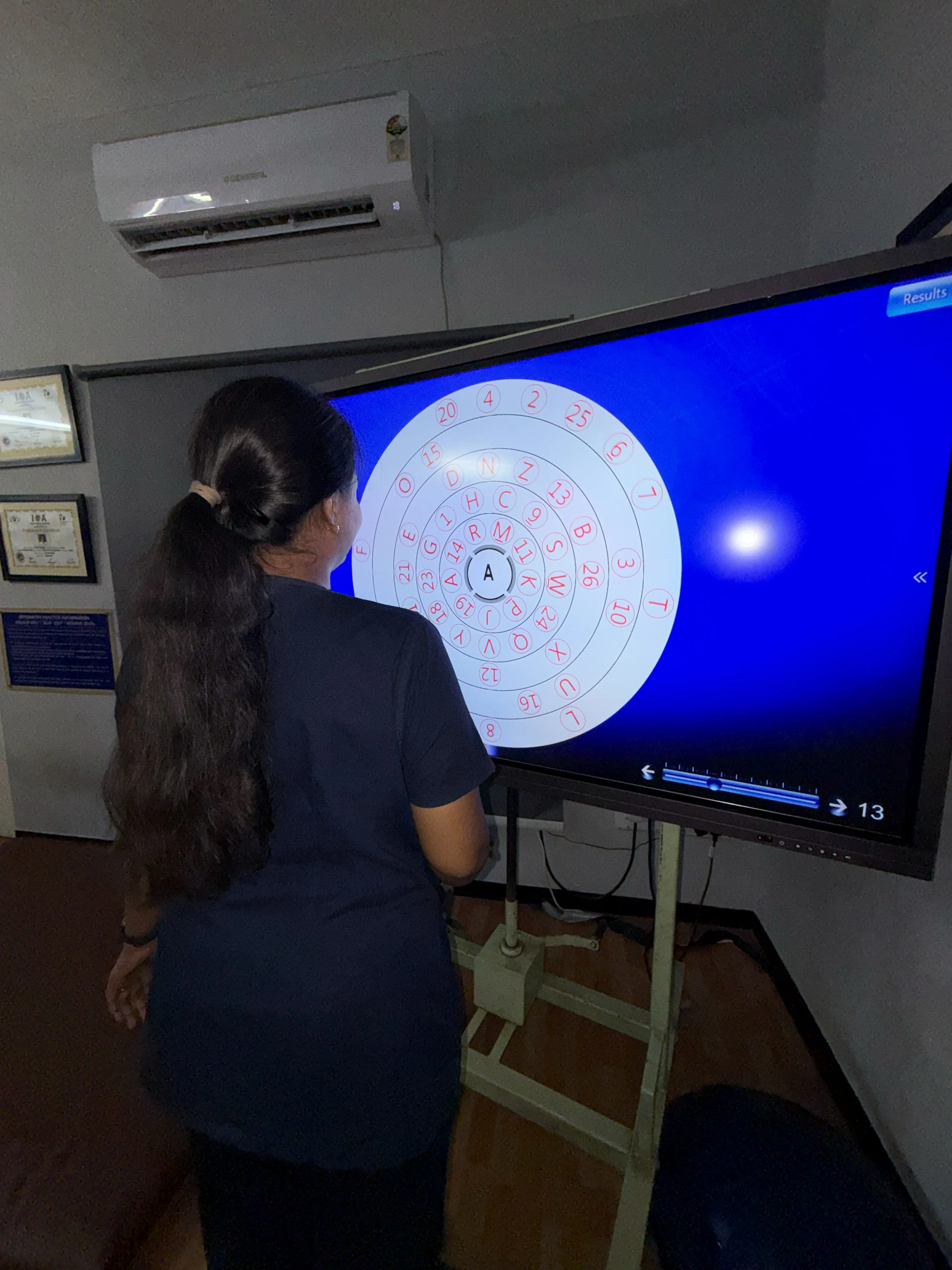 Caring Vision Therapy Ashok Nagar Chennai - Patient and therapist during visual tracking therapy session on display screen