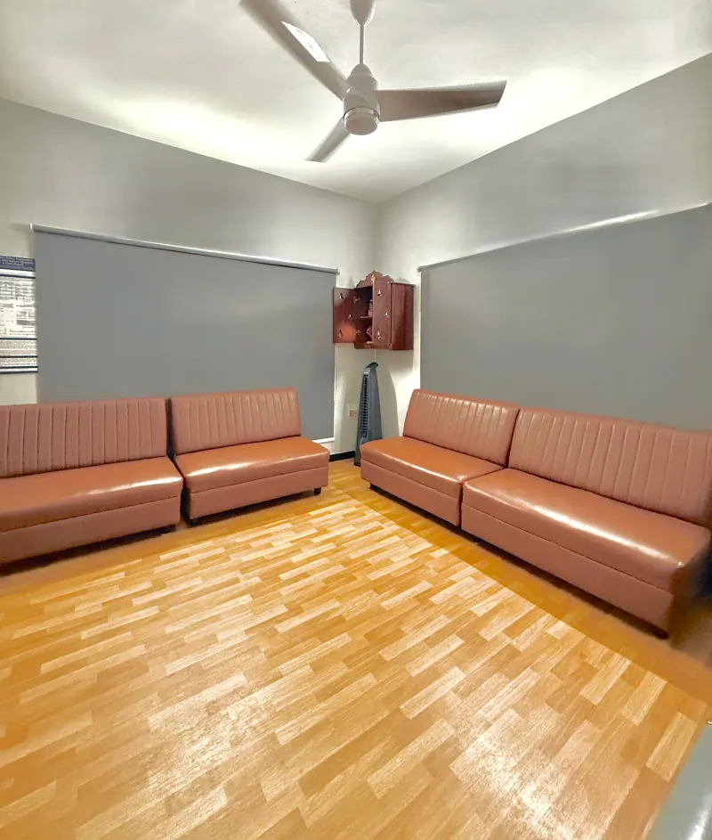 Caring Vision Therapy Ashok Nagar Chennai - Patient waiting area with comfortable leather sofas