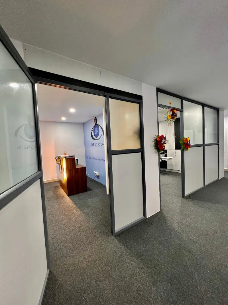 Caring Vision Therapy Hyderabad - Clinic interior entrance showing glass-partitioned consultation rooms and reception