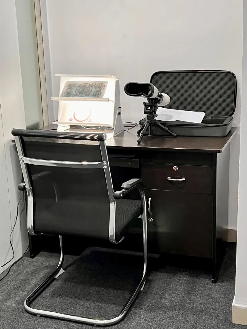 Caring Vision Therapy Hyderabad - Diagnostic equipment desk featuring synoptophore, light box and vision assessment instruments