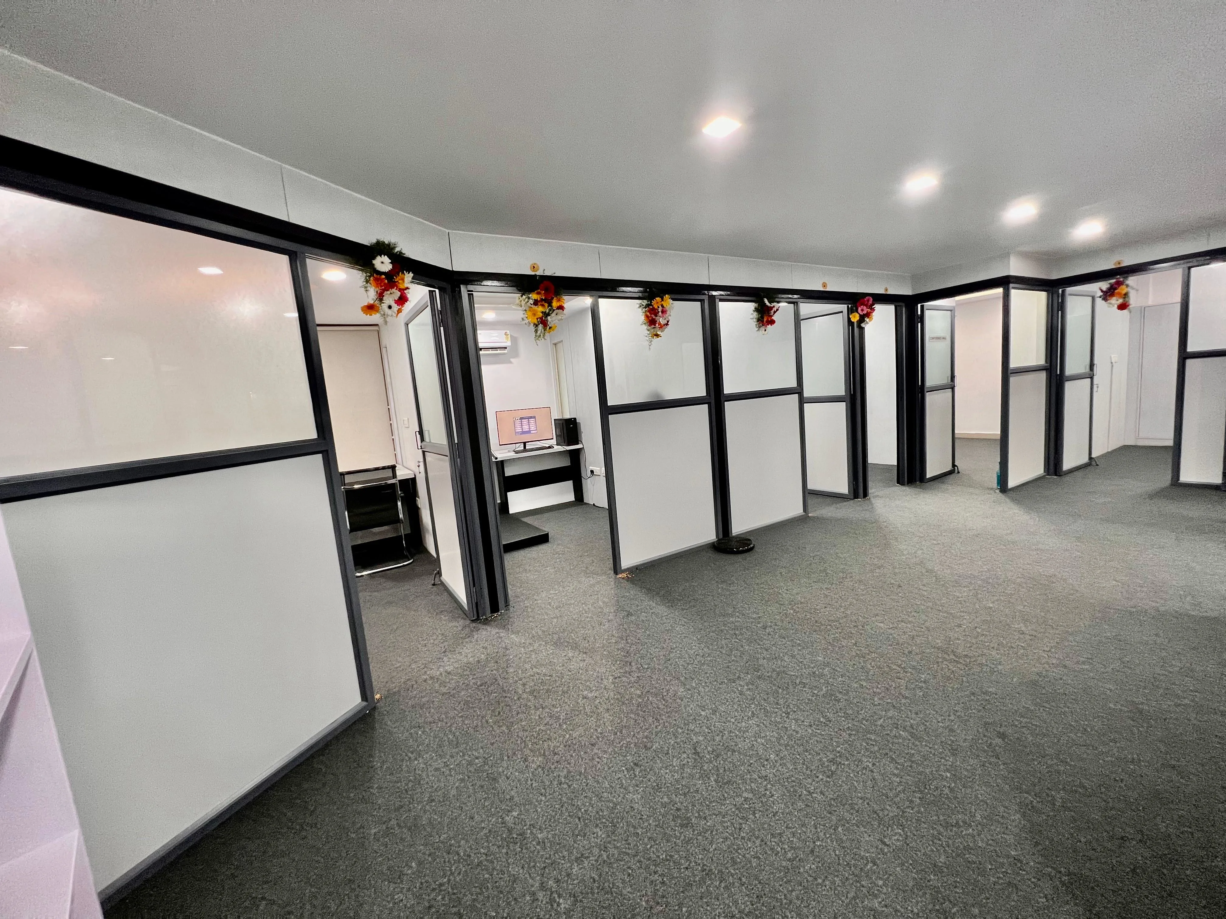 Caring Vision Therapy Hyderabad – Full therapy floor overview with multiple glass-partitioned treatment rooms