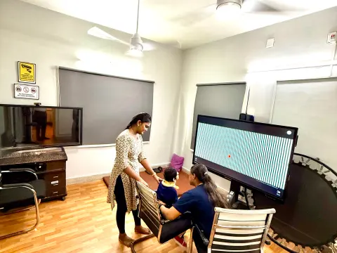 Therapist guiding a child through a screen-based vision therapy activity at Caring Vision Therapy